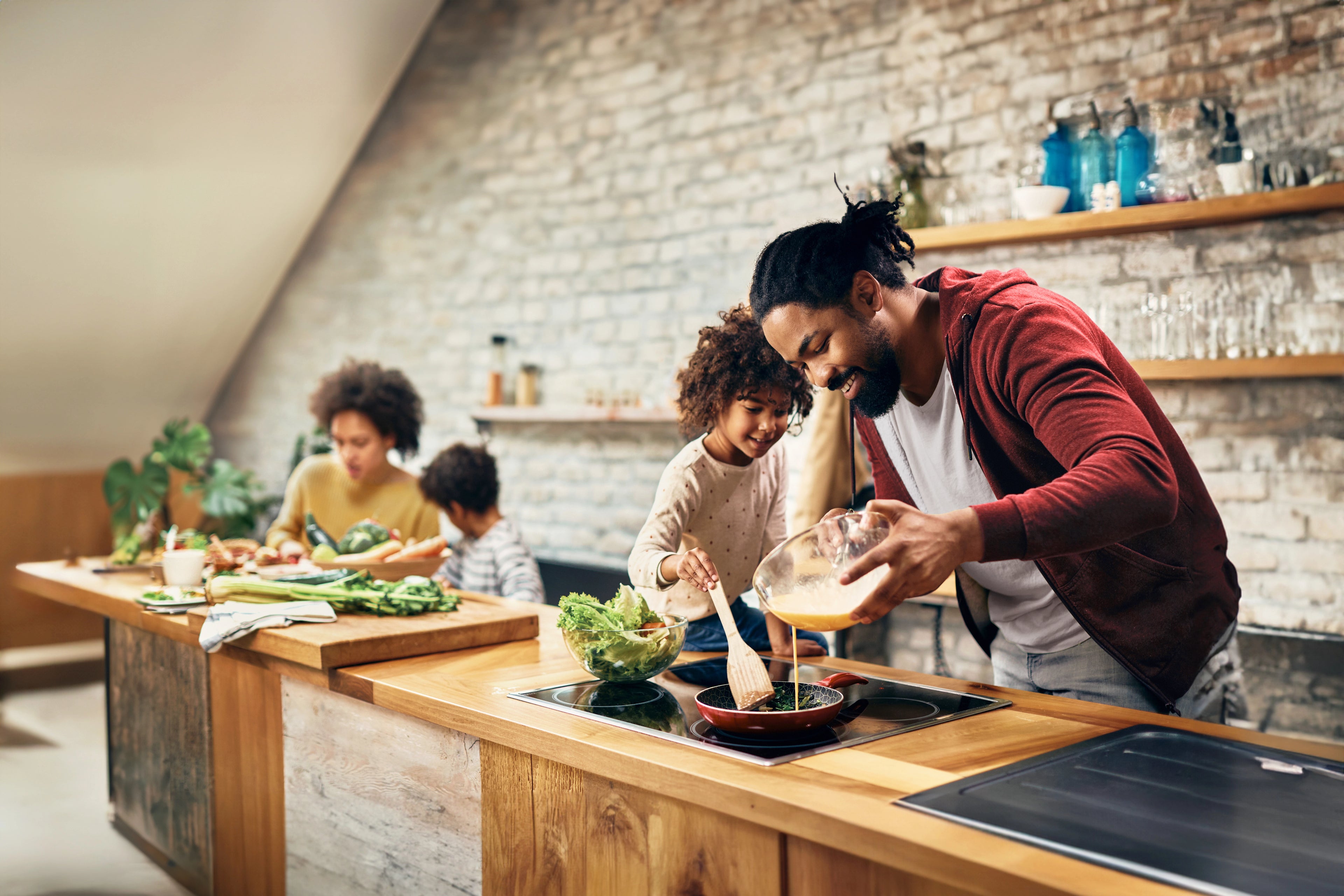 Family cooking together with peace of mind knowing FireAvert will keep them safe from kitchen fires